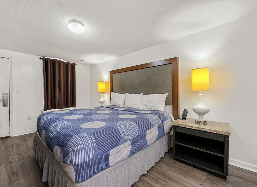 Extended Stay Studios Montgomery room with king bed, bedside lamps, and nightstand