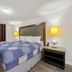 Extended Stay Studios Montgomery room with king bed, bedside lamps, and nightstand
