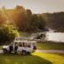 Eriksberg Hotel & Nature Reserve safari vehicle by lakeside at sunset in Hällaryd, Blekinge County