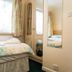 The Glendeveor in Newquay: compact guest room with single bed, wardrobe, and window light