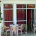 Hotel Casa di William in Khajurāho with outdoor patio tables and chairs beside a restaurant entrance