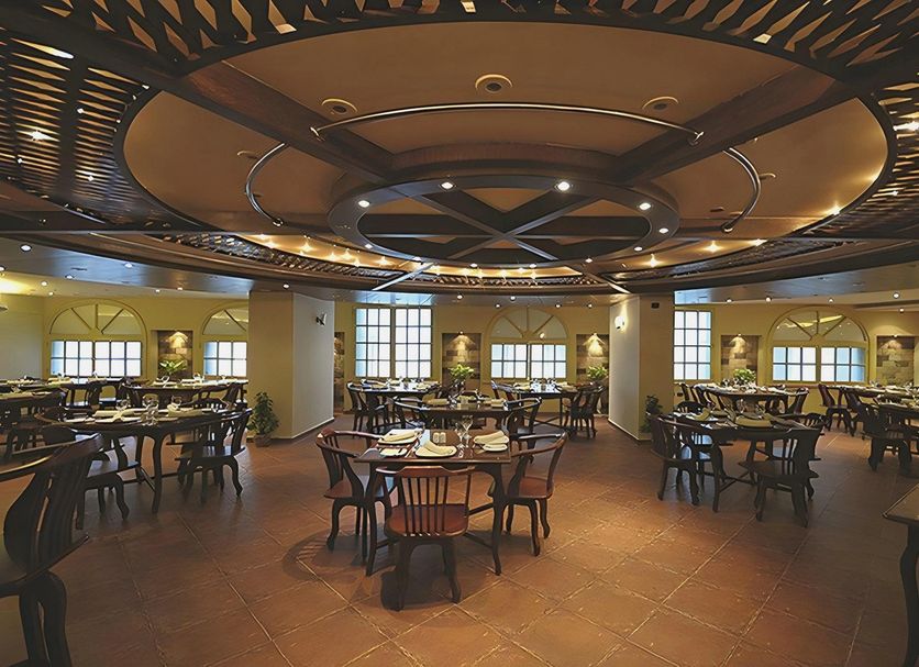 Cherry Maryski Hotel Alexandria restaurant with round tables and ornate ceiling lighting