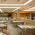 Hotel RH Vinaròs Playa in Vinaròs restaurant with modern dining tables, buffet counters and ceiling lights