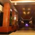 Golden Tulip Kumasi City entrance walkway with illuminated columns and a glowing fountain in Kumasi