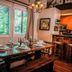 Pine Mountain Club Chalets Resort dining room with set table, wood benches, and kitchen bar in Pine Mountain