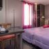 Hotel Montsouris Orleans room in Paris with twin beds, desk and pink curtains