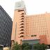 Central Hotel Fukuoka exterior in Fukuoka, tall peach building with many windows and street trees