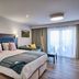 Llanerch Vineyard Hotel Pontyclun guest room with king bed, sofa and balcony doors