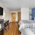 SureStay Plus by Best Western Niagara Falls East room with two beds, desk, and wall-mounted TV in Niagara Falls