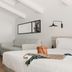 Room Mate Collection Helen Berger in Valencia: bright minimalist hotel room with sofa, bed, and wooden floor