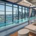 W Sydney rooftop infinity pool with city and harbor views, plus cabana loungers and daybeds