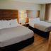 Quality Inn & Suites By the Parks, Kissimmee: guest room with two beds, bedside lamp, and window