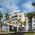 Fairfield Inn & Suites by Marriott Orange Beach exterior with palm trees and covered entrance