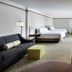 Hilton Garden Inn Montreal Airport room with two beds, sofa, desk and TV in Montreal