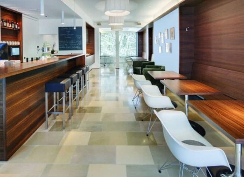 Stern am Rathaus Cologne hotel lobby with bar, high stools, and seating along a bright corridor