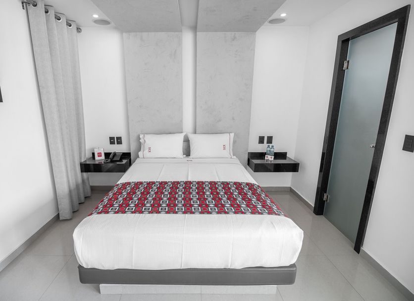 Six Hotel Guadalajara Expiatorio guest room with double bed and bedside tables in Guadalajara