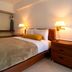 Solace by the Sea in Ponce hotel room with king bed, bedside lamps, and warm neutral decor