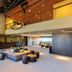 Montanya Hotel & Lodge in Seva lobby with stone wall, mezzanine, and lounge seating