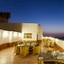 Ginger Jaipur rooftop terrace dining area with city lights at dusk in Jaipur