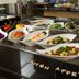 Bildungshaus St Bernhard Rastatt buffet with assorted salads and vegetables behind glass