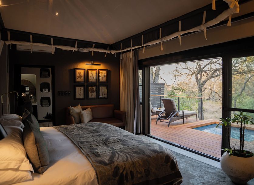 Simbambili Game Lodge in Phungwe bedroom with sliding doors to private deck and plunge pool