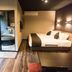Livemax Resort Hakone Ashinoko room with bed and private round soaking tub in Hakone