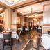 Hotel Bothwell Sedalia Central District dining room with tables and chairs in warm wood-paneled interior