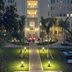 British Colonial Nassau courtyard at night with palm trees, lit walkway, and outdoor lounge seating