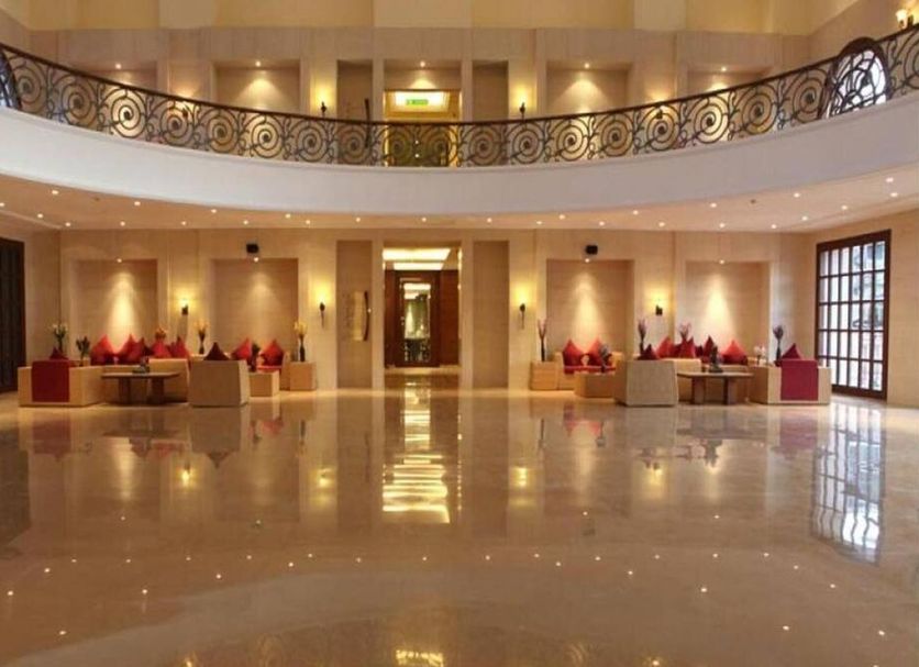 Evershine Resort & Spa, Mahabaleshwar lobby with polished floors, chandeliers and curved balcony