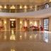 Evershine Resort & Spa, Mahabaleshwar lobby with polished floors, chandeliers and curved balcony