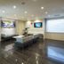 Jr-East Hotel Mets Nagaoka lounge with seating, wall-mounted TVs and glossy dark tile floor in Nagaoka