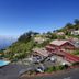 Village Cabo Girao in Câmara de Lobos with ocean views, hillside buildings, and an outdoor pool