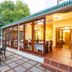 Evergreen Manor and Spa, Stellenbosch: glass-enclosed patio dining area with outdoor seating and garden view