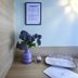 Hotel Kunterbunt in Wurzburg room corner with purple vase, framed notice, and glasses on tray