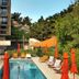 Hotel Aquarius Dubrovnik pool deck with loungers, umbrellas and hillside view in Dubrovnik