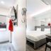 Easy Planet Bangkok Surawong guest room with queen bed, wall-mounted TV and desk in Bangkok