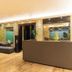 Hotel Golden Treat, Indore lobby with gray sectional seating, reception desk and warm lighting