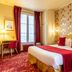 Hotel Romance Malesherbes by Patrick Hayat room in Paris with red accents and patterned wallpaper