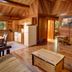 Tigh-Na-Mara Seaside Spa Resort in Parksville, rustic cabin living room with stone fireplace and kitchen