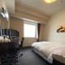 Hotel Route-Inn Koriyama Minami guest room with bed, desk, chair, and window in Kōriyama