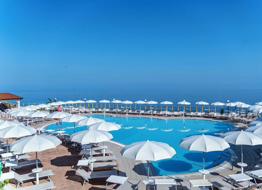 Il Poggio Di Tropea in Parghelia: seaside pool with white umbrellas and loungers overlooking the sea