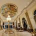 Hotel Ambica Empire Chennai lobby with ornate ceiling mural, chandelier and marble columns