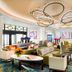 Disney's Riviera Resort lobby in Lake Buena Vista with curved ring chandelier and colorful seating