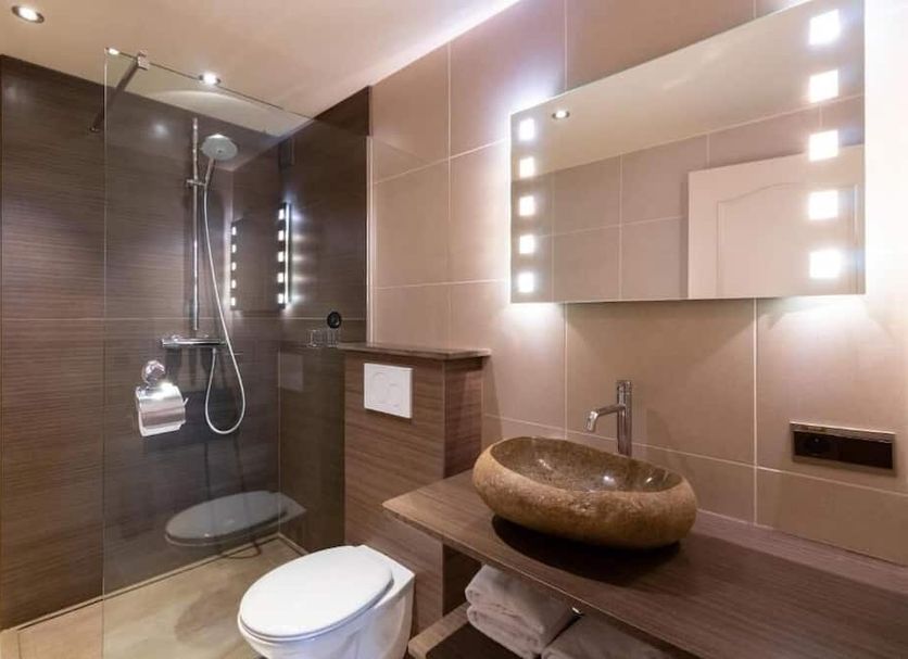 Hotel Torenhof in Sint Martens Latem bathroom with walk-in shower, vessel sink and lit mirror