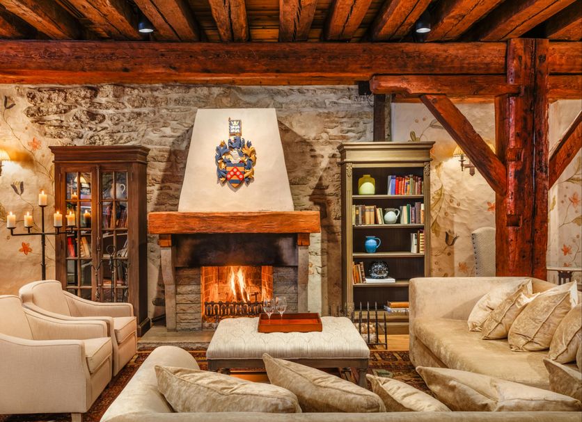 Schlössle Hotel in Tallinn lounge with stone fireplace, armchairs and wooden beams