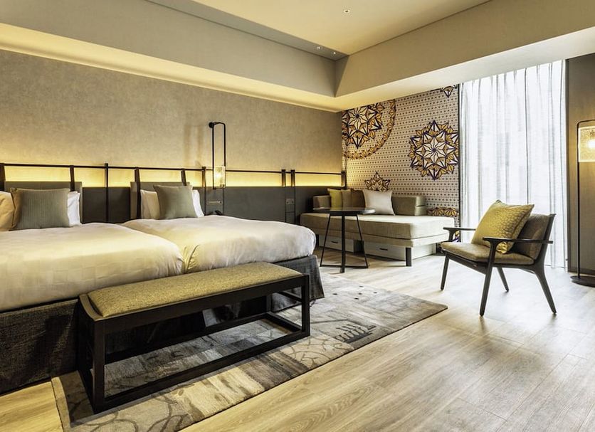 Tokyo Bay Shiomi Prince Hotel in Tokyo guest room with two beds, sofa seating, and large window