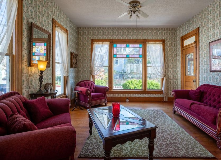 5 Ojo Inn Bed & Breakfast in Eureka Springs parlor with stained-glass windows and burgundy seating