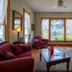 5 Ojo Inn Bed & Breakfast in Eureka Springs parlor with stained-glass windows and burgundy seating