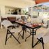 Aht Colonial Hostel in Havana rooftop dining terrace with table, chairs, and city views