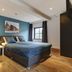 Hotel Brasserie Den Engel room in Baarle-Nassau with blue walls, king bed, and window view